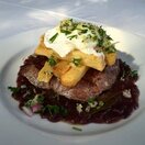 lucky bean “Portuguese steak” - rump with red wine & onion gravy, a gremolata of lemon zest, parsley, garlic & onion, fat chips & a soft, poached egg